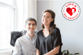 Couple smiling in a bright room with a "Love & Decorating" logo on the wall.