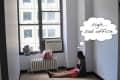 Empty office with a woman sitting on the floor, thinking "sigh... sad office," next to a window and radiator.