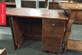Wooden desk with three drawers and brass knobs, labeled "Before."