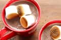 Hot cocoa topped with marshmallows in a red mug