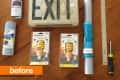 Materials for DIY project: EXIT sign, spray paint, light bulbs, ruler, screwdriver, cords, and contact paper on a wooden table.
