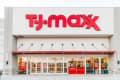 T.J.Maxx storefront with large red logo, glass entrance, and "now hiring" sign.