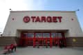 Entrance of a Target store with red signage, shopping carts, and people entering and exiting.