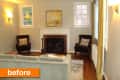 Living room with a white fireplace, two dark armchairs, a light sofa, and a painting above the mantel.