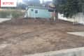 Dirt-covered yard with a small green house in the background, labeled "Before."