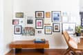 A wall of framed art, gallery-style