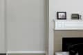 Arched wall niche beside a fireplace mantel with framed photo and decor.