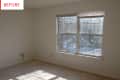 Empty room with beige carpet, large window, and white walls, labeled "Before" in the top left corner.