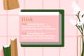 Definition of "Risk" on a pink background with books, a lamp, and flowers.
