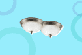 Two brushed nickel flush mount ceiling lights with frosted glass domes on a blue background with circular patterns.