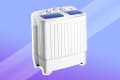 Portable twin tub washing machine with control knobs and blue lids.