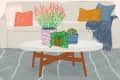 Living room with a white sofa, colorful cushions, and a coffee table featuring potted plants and a cactus.