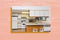 Kitchen with white cabinets, wood accents, stove, fridge, microwave, and two stools at the island counter.