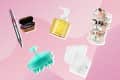 Hair styling tool, skincare pump bottle, makeup organizer, scalp massager, and white towels on a pink background.
