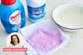 Laundry products with a stained cloth, including Persil detergent, Clorox bleach, and a bowl of water.