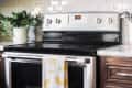 oven stovetop in kitchen with dish towel hanging