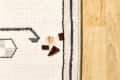 overhead shot of a the edge of a rug with a few pieces of chocolate on it.