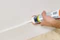 head on shot of the caulk being used on a baseboard