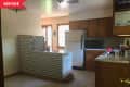 Before: 1950s Kitchen with wood cabinets and beige walls