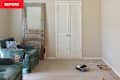 Before: beige living room with beige carpeting and semi-flushmount overhead light