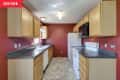 Before: Galley kitchen with red walls and yellowy oak cabinets