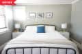 Before: Gray bedroom with iron bed