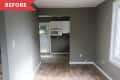 Empty room with wood floors, gray walls, and a small kitchen area with white cabinets and a microwave.