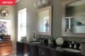 Before: Dark bathroom with traditional wood vanity