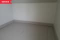Before: Empty space with gray floors and white walls