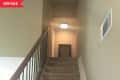 Before: Dim brown-carpeted stairs
