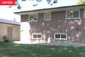 Before: Plain exterior of a house, viewed from the backyard