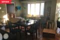 Before: Dining room with black table in front of window