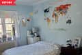Before: Bed without headboard and world map above