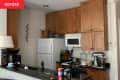 Before: kitchen with brown cabinets and black counters