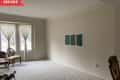Before: Empty living room with beige walls and beige carpet