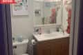 Before: White bathroom with stained wood vanity