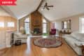 Before: Large living room with tall brick fireplace and honey oak floors
