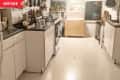 Before: White kitchen with white floors and black countertops