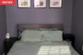 Before: Bedroom with dark gray-purple walls and black nightstands