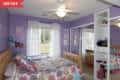 Before: Small kid's bedroom with purple walls and mirrored closet doors