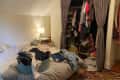 Before: Clothes piled on bed and in closet with no doors, only curtains