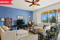 Before: Living room with '90s-00s-era furniture and blue accent wall