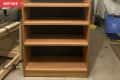 Before: plain wood shelf in a garage setting