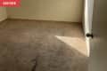 Before: Dingy white bedroom with stained brown carpet