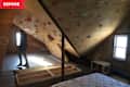 Rock climbing wall and mattress in unfinished attic