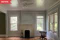 Before: Empty living room with old brick fireplace and dirt and dust-covered walls