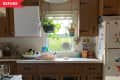 Before: Dated kitchen with brown laminate cabinetry with dark hinges