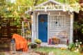 View of fall porch with seating, blankets, and potted plants