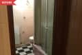 Before: Dated bathroom with black and white checkerboard floors and pink shower base