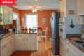 Before: kitchen with white cabinets and muted orange walls